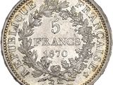 a silver coin with a wreath on the front of it