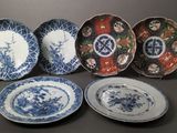 six blue and white plates with designs of flowers on them