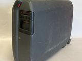 a gray suitcase sitting on a white surface