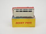 boxed dinky toy bus in box on white surface with yellow box