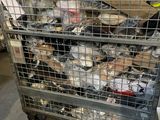 a metal cage filled with assorted items in a warehouse