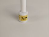 a close up of a bottle of nail polish on a white surface