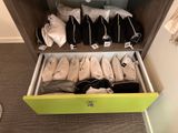 a green drawer filled with lots of bags of clothes