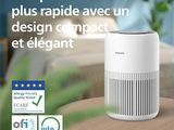 a white air purifier sitting on top of a wooden table