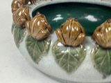 a picture of a ceramic bowl with a bunch of figurines in it