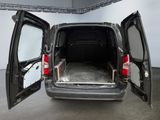 a van with its doors open in a garage