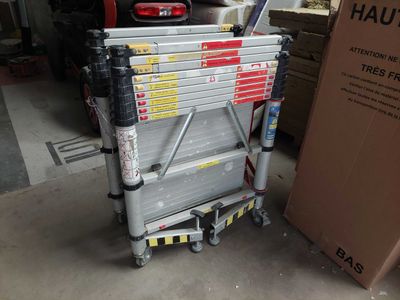 a picture of a stack of boxes sitting on a cart in a garage