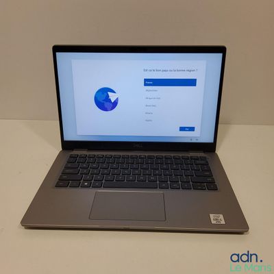 un ordinateur portable ouvert posé sur une table blanche