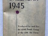 an old book with a red button on it sitting on a table
