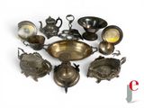 a lot of antique silverware on display on a table