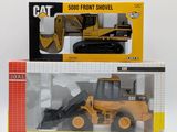 a box with a toy bulldozer and a box with a toy bulldozer in it