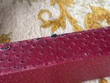 a red brick sitting on top of a yellow and white rug