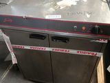 an image of a commercial dishwasher in a warehouse