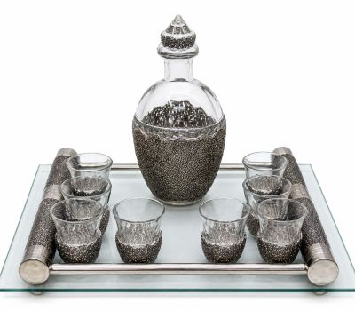a glass tray with a bottle and glasses on it