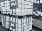 several large white containers stacked on top of each other in a parking lot