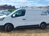 the van is parked in a lot with other cars in the background
