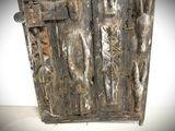 an old wooden door with metal latches on it