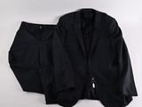 black suit and tie laying on a white surface