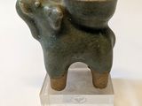 a statue of an elephant with a bowl on it ' s back