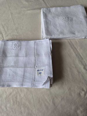 two towels that are on a bed with a name on them