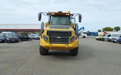 a large yellow truck that is parked in a parking lot