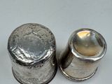 pair of silver salt and pepper shakers on a white surface