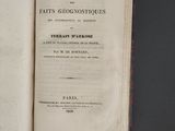 an open book on a table with a black background