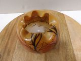 a small bowl that is sitting on a wooden plate