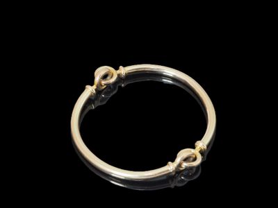 gros plan d'une bague en or sur fond noir