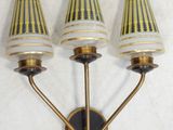 three lamps that are on the wall next to each other