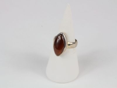 an image of a ring with a red stone on top of a white cone