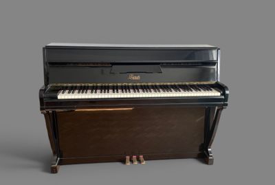 a piano that is sitting on a gray surface