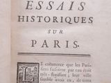 an open book with a picture of a building in the background