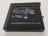 the back panel of a laptop computer with a purple sticker on it