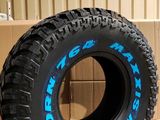 a tire that is sitting on the ground in front of a box