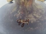 a close up of a vase with a bug on it