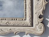 a picture of a mirror on the wall with a sky in the background