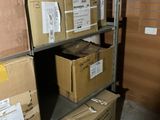 boxes are stacked on a shelf in a room with a brick wall