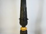 a black and gold lamp that is on a table