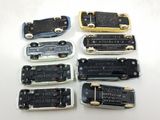 many different types of cell phones sitting on a table