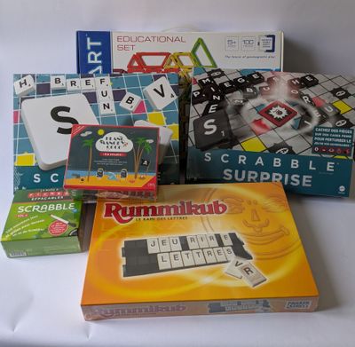 a pile of board games on a white table