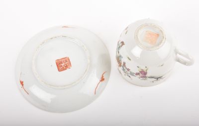 a small cup and saucer sitting on a white table
