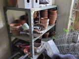 many pots and other items on a shelf in a room