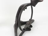 a statue of a bird that is sitting on a branch