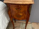a small wooden table with a drawer on top of it