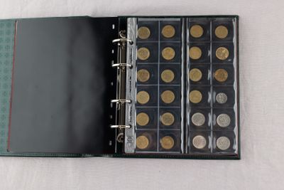 a black binder with a bunch of coins inside of it
