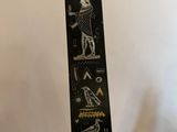 an image of a black and gold egyptian obelisk on a white background