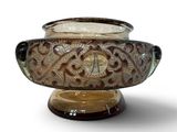 a glass bowl with a lid that has a design on it
