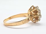 an image of a gold ring with a diamond center stone