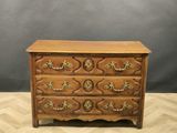 an antique chest of drawers with ornate carvings and brass handles